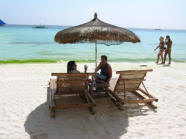 Batangas beach with tourist relaxing on the sand.