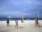 Tourist playing beach volleyball at Boracay beach.